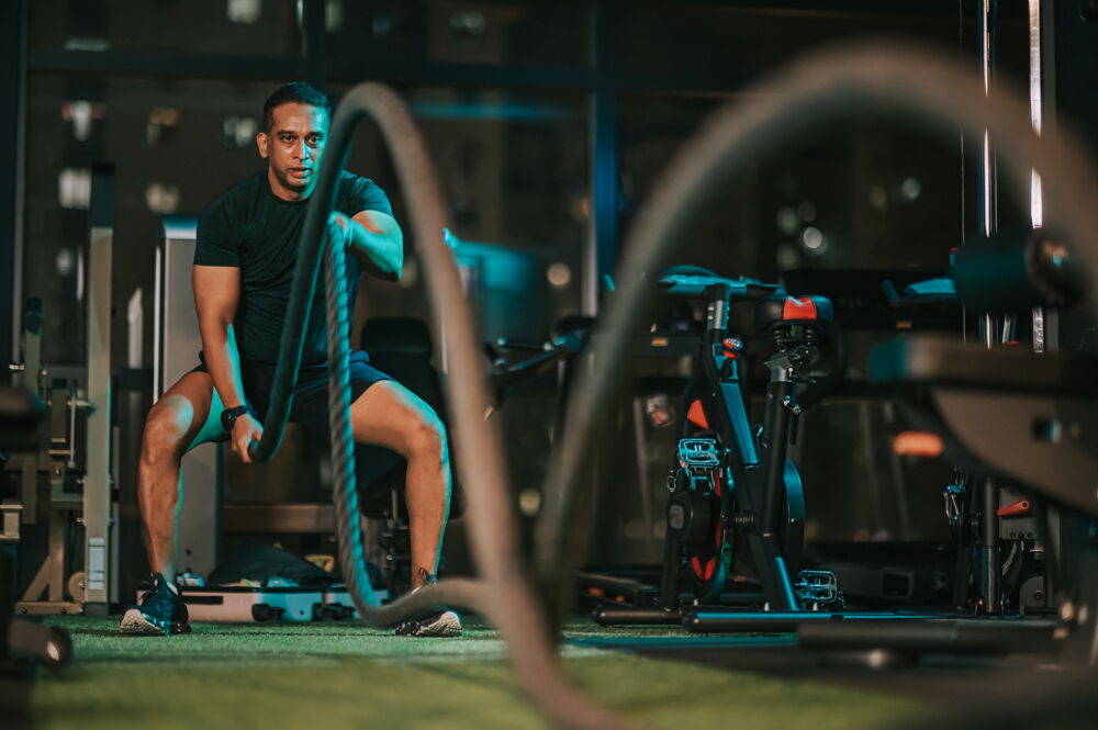 man in gym with ropes